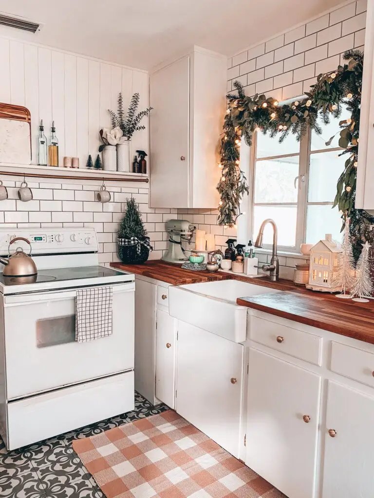 Kitchen Christmas garland over kitchen sink plus oven and other decor