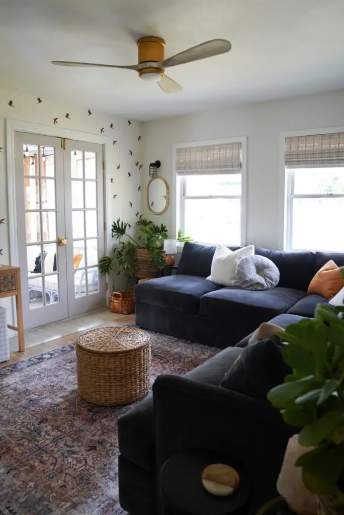 living room with dark sofa and wallpaper