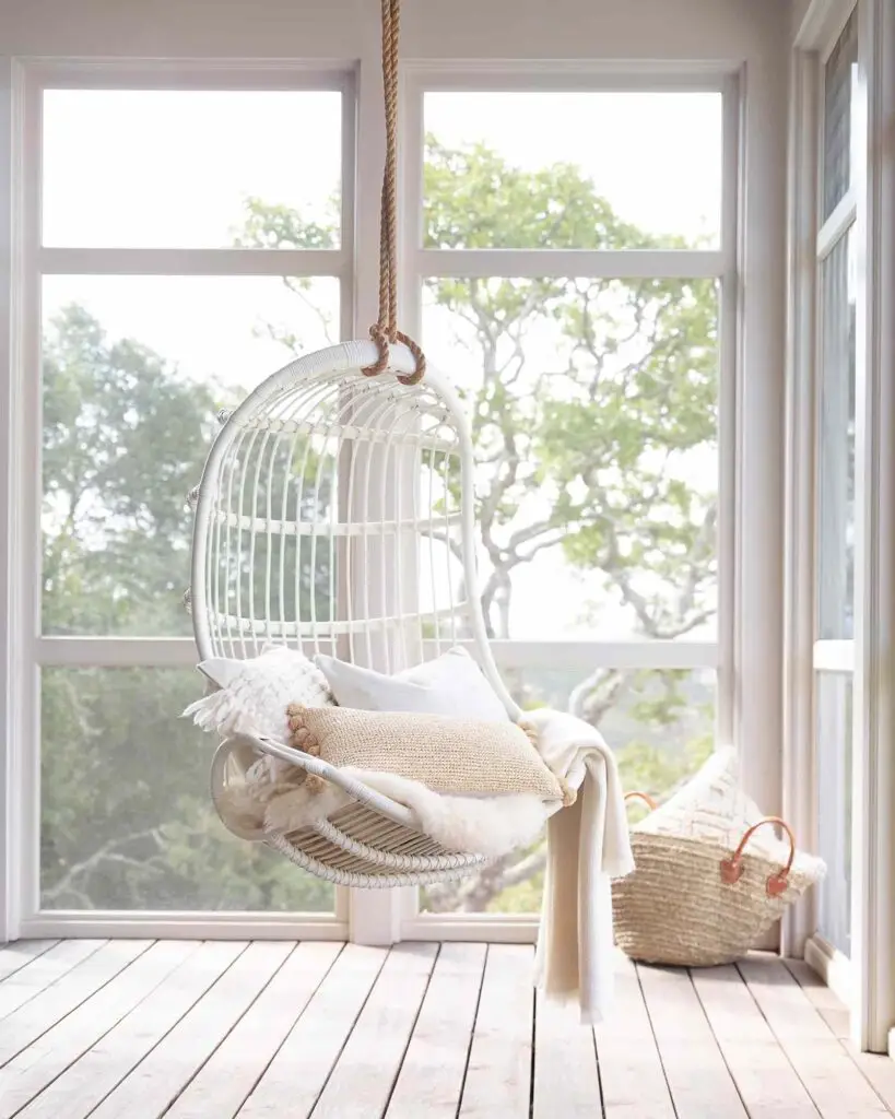 white hanging swing chair on porch